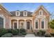 Brick home with white columns and detailed trim. Landscaped front yard with lush greenery at 2760 Veltre Sw Ter, Atlanta, GA 30311