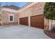 Two-car garage with brown doors and stone accents at 2760 Veltre Sw Ter, Atlanta, GA 30311