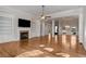 Large Gathering room with hardwood floors, fireplace, and views into adjacent rooms at 2760 Veltre Sw Ter, Atlanta, GA 30311