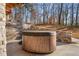 Hot tub on patio with stone wall and wooded backdrop at 2760 Veltre Sw Ter, Atlanta, GA 30311