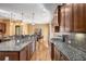 Open kitchen with island, granite countertops, and hardwood floors at 2760 Veltre Sw Ter, Atlanta, GA 30311