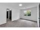 Well-lit bedroom with neutral walls, grey carpet, and double closets at 3569 Lynne Rd, Powder Springs, GA 30127