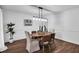 Charming dining room with hardwood floors, an oval table, and stylish light fixture at 3569 Lynne Rd, Powder Springs, GA 30127