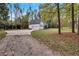 House exterior showcasing a white home and a gravel driveway at 3569 Lynne Rd, Powder Springs, GA 30127