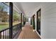 Long front porch with wooden deck and black railings at 3569 Lynne Rd, Powder Springs, GA 30127