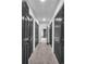 Long hallway with dark doors and grey carpet leading to other rooms at 3569 Lynne Rd, Powder Springs, GA 30127