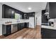 Modern kitchen with dark cabinetry, quartz countertops, and stainless steel appliances at 3569 Lynne Rd, Powder Springs, GA 30127