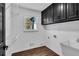 Laundry room with dark cabinets, window, and vinyl flooring at 3569 Lynne Rd, Powder Springs, GA 30127