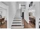 Modern staircase with dark wood treads and white risers at 3569 Lynne Rd, Powder Springs, GA 30127