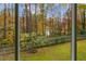 Landscaped backyard with pond view from screened porch at 3799 Halisport Nw Ln, Kennesaw, GA 30152