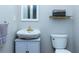 Small bathroom with pedestal sink, toilet, and shelf at 3799 Halisport Nw Ln, Kennesaw, GA 30152