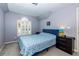 Bright bedroom with a queen bed, window with shutters, and a dresser at 3799 Halisport Nw Ln, Kennesaw, GA 30152