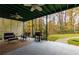 Spacious covered patio features ceiling fans and tranquil wooded views at 3799 Halisport Nw Ln, Kennesaw, GA 30152