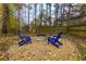 Blue chairs and fire pit in backyard with gravel at 3799 Halisport Nw Ln, Kennesaw, GA 30152