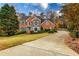 Brick house exterior with circular driveway and landscaping at 3799 Halisport Nw Ln, Kennesaw, GA 30152