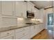 White kitchen with granite countertops and stainless steel appliances at 3799 Halisport Nw Ln, Kennesaw, GA 30152