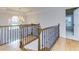 Elegant upstairs hall with wood flooring and iron railing at 3799 Halisport Nw Ln, Kennesaw, GA 30152