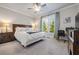 Bright bedroom with king-size bed, workspace, and backyard view at 4016 Matty Ne Dr, Marietta, GA 30066