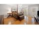 Serene main bedroom featuring a four-poster bed, sitting area, and private access to the outdoors at 10 Moss Landing Se Rd, Acworth, GA 30102