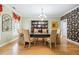 Formal dining room with elegant decor, stylish wallpaper, hardwood floors, and ample seating at 10 Moss Landing Se Rd, Acworth, GA 30102