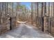 Private gated driveway leading to a secluded home surrounded by lush greenery and mature trees at 10 Moss Landing Se Rd, Acworth, GA 30102