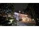 Two-story house exterior at night, covered in snow, with landscaping and lighting at 10 Moss Landing Se Rd, Acworth, GA 30102