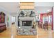 Beautiful stone fireplace as a focal point, complemented by hardwood floors and natural light at 10 Moss Landing Se Rd, Acworth, GA 30102