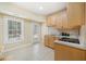 This kitchen has light wood cabinets and a large window looking out onto a treed yard at 10 Moss Landing Se Rd, Acworth, GA 30102