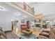 Open-concept living room featuring hardwood floors, a stone fireplace, and comfortable seating at 10 Moss Landing Se Rd, Acworth, GA 30102