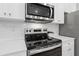 Stainless steel stove and microwave in white kitchen at 8194 Tiger Way, Riverdale, GA 30274