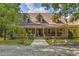 Two story home with wrap around porch, stone walkway, and landscaping at 897 Winding Trl, Lawrenceville, GA 30046