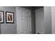 Bright hallway with two white doors and framed artwork at 2185 Fairfield St, Smyrna, GA 30080