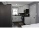 Modern kitchen with white cabinets, stainless steel appliances, and dark tile backsplash at 2185 Fairfield St, Smyrna, GA 30080