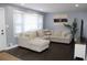 Spacious living room with L-shaped sofa and dark hardwood floors at 2185 Fairfield St, Smyrna, GA 30080