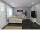 Living room with L-shaped sofa and dark hardwood floors at 2185 Fairfield St, Smyrna, GA 30080