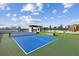 Well-maintained outdoor tennis court with surrounding green space at 2425 Peachtree Ne Rd # 701, Atlanta, GA 30305