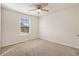 Bedroom with ceiling fan, window and neutral colored walls at 412 Vermeer Ct, Locust Grove, GA 30248