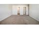 A bright bedroom with neutral carpet, walk-in closet and attached full bathroom at 412 Vermeer Ct, Locust Grove, GA 30248