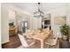 Bright dining room boasts modern lighting, wood floors and flows easily into other living spaces at 412 Vermeer Ct, Locust Grove, GA 30248