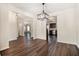 Bright dining room features dark hardwood floors and a modern chandelier at 412 Vermeer Ct, Locust Grove, GA 30248