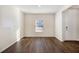 Simple dining room with dark hardwood floors and a single window at 412 Vermeer Ct, Locust Grove, GA 30248