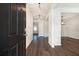 Bright entryway with dark hardwood floors and modern light fixtures at 412 Vermeer Ct, Locust Grove, GA 30248