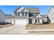 Two-story house with gray siding, brick accents, and a white door at 412 Vermeer Ct, Locust Grove, GA 30248