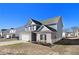 Two-story house with gray siding, brick accents, and a white door at 412 Vermeer Ct, Locust Grove, GA 30248