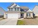 Two-story house with gray siding, brick accents, and a white door at 412 Vermeer Ct, Locust Grove, GA 30248