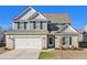 Two-story house with gray siding, brick accents, and a white door at 412 Vermeer Ct, Locust Grove, GA 30248