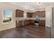 Modern kitchen with dark wood cabinets and stainless steel appliances at 412 Vermeer Ct, Locust Grove, GA 30248