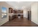 Modern kitchen with dark wood cabinets and stainless steel appliances at 412 Vermeer Ct, Locust Grove, GA 30248