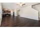 Spacious living room with dark hardwood floors and a ceiling fan at 412 Vermeer Ct, Locust Grove, GA 30248