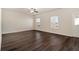 Spacious living room with dark hardwood floors and ceiling fan at 412 Vermeer Ct, Locust Grove, GA 30248